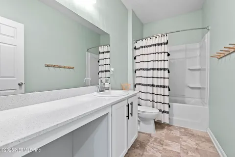 a view of walk in closet with furniture and a refrigerator