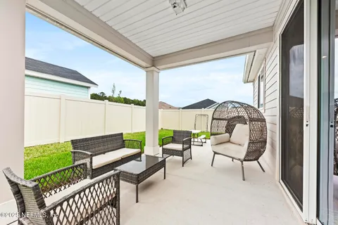 a view of a house with backyard and porch