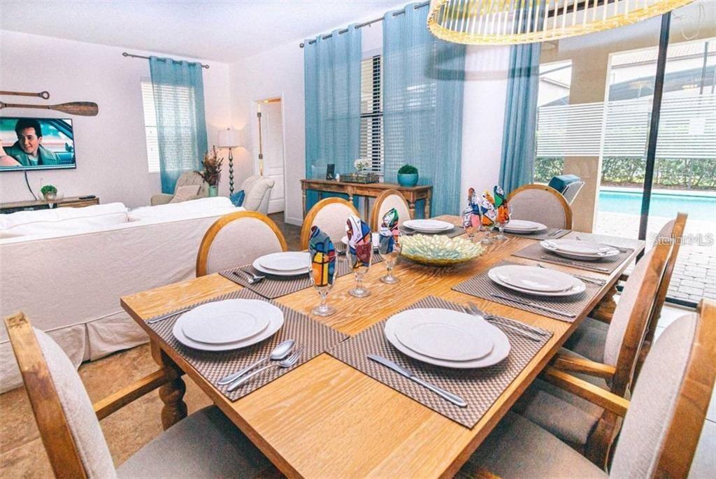 1427 Thunderbird Road Davenport, FL 33896 - Photo 12 of 52 a dining room with furniture and a large window