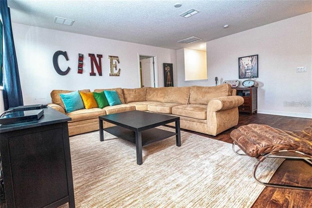 1427 Thunderbird Road Davenport, FL 33896 - Photo 13 of 52 a living room with furniture and a wooden floor