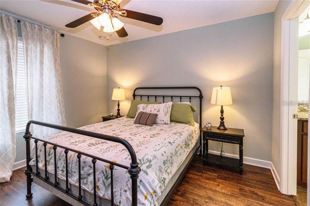 1427 Thunderbird Road Davenport, FL 33896 - Photo 16 of 52 a bedroom with a bed and a chandelier