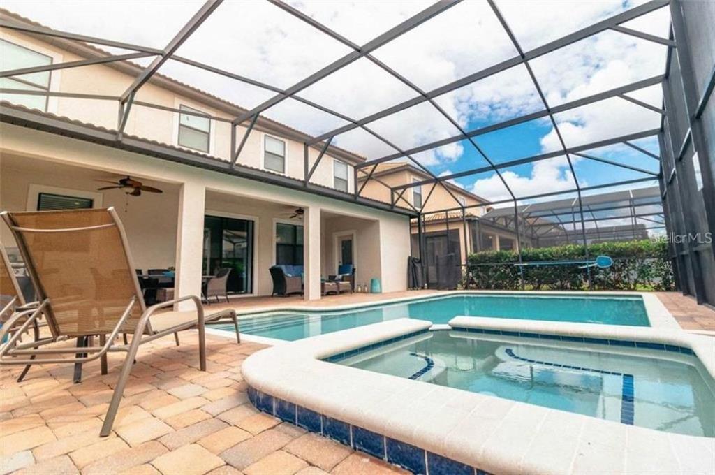 1427 Thunderbird Road Davenport, FL 33896 - Photo 17 of 52 a view of a patio with a table and chairs and a barbeque