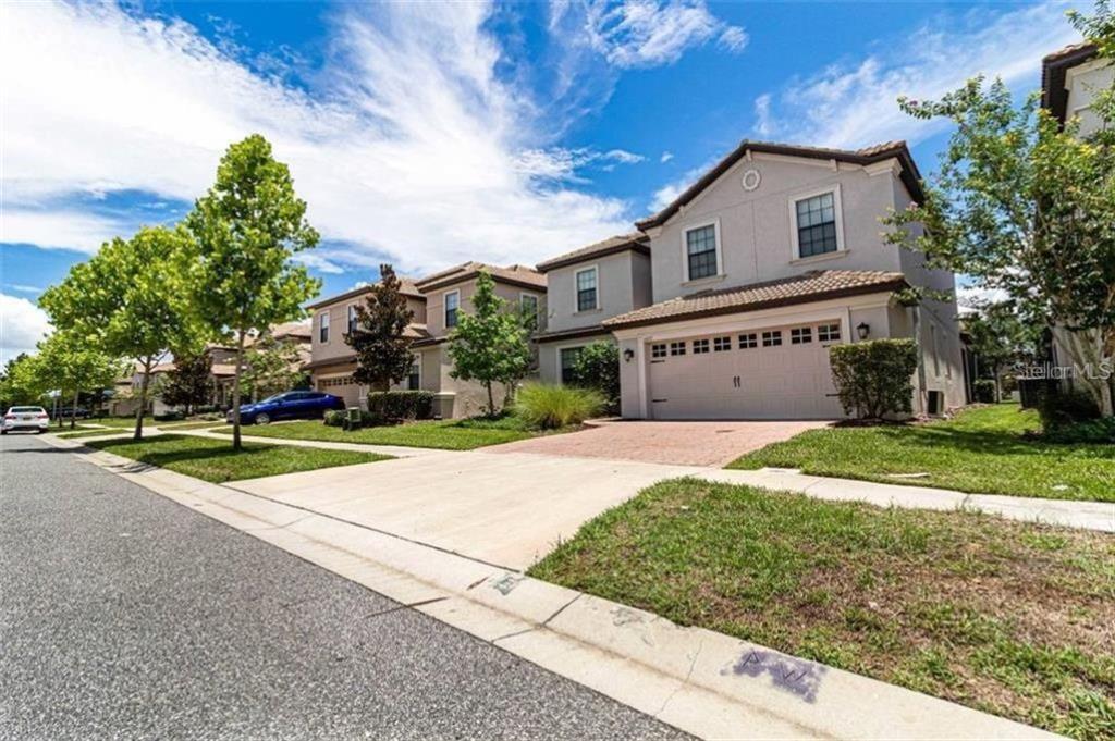 1427 Thunderbird Road Davenport, FL 33896 - Photo 2 of 52 a front view of a house with a yard and garage