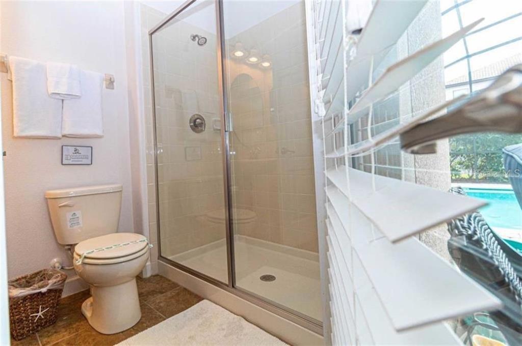 1427 Thunderbird Road Davenport, FL 33896 - Photo 22 of 52 a bathroom with a sink toilet and shower