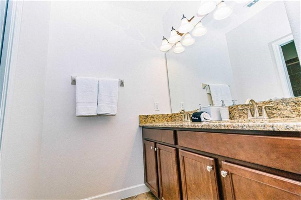 1427 Thunderbird Road Davenport, FL 33896 - Photo 28 of 52 a room with a sink and a mirror