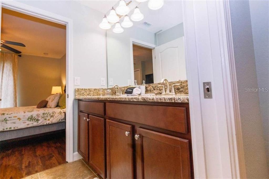 1427 Thunderbird Road Davenport, FL 33896 - Photo 30 of 52 a en suite bathroom with a sink and a mirror