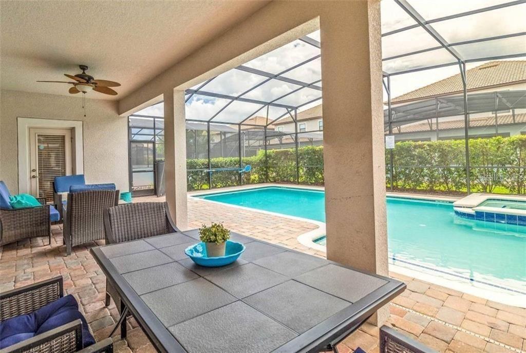 1427 Thunderbird Road Davenport, FL 33896 - Photo 3 of 52 a view of a dining room and livingroom with furniture wooden floor and garden view