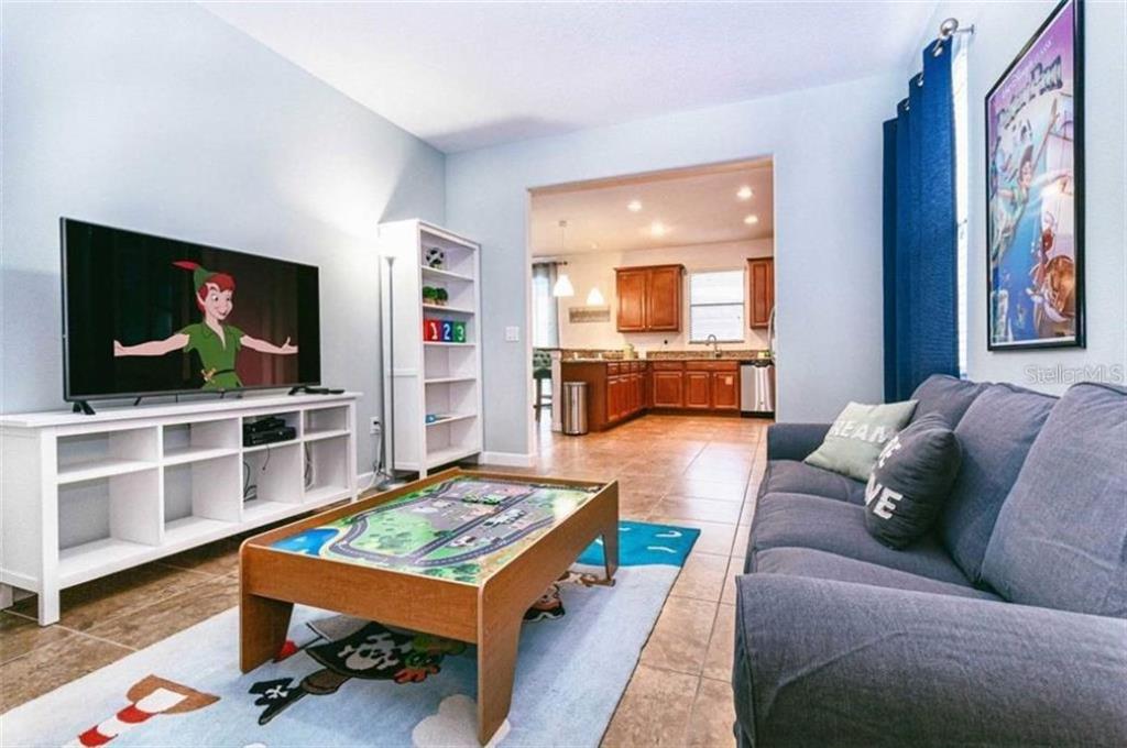 1427 Thunderbird Road Davenport, FL 33896 - Photo 33 of 52 a living room with furniture and a flat screen tv