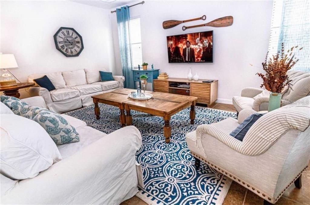 1427 Thunderbird Road Davenport, FL 33896 - Photo 4 of 52 a living room with furniture and a flat screen tv