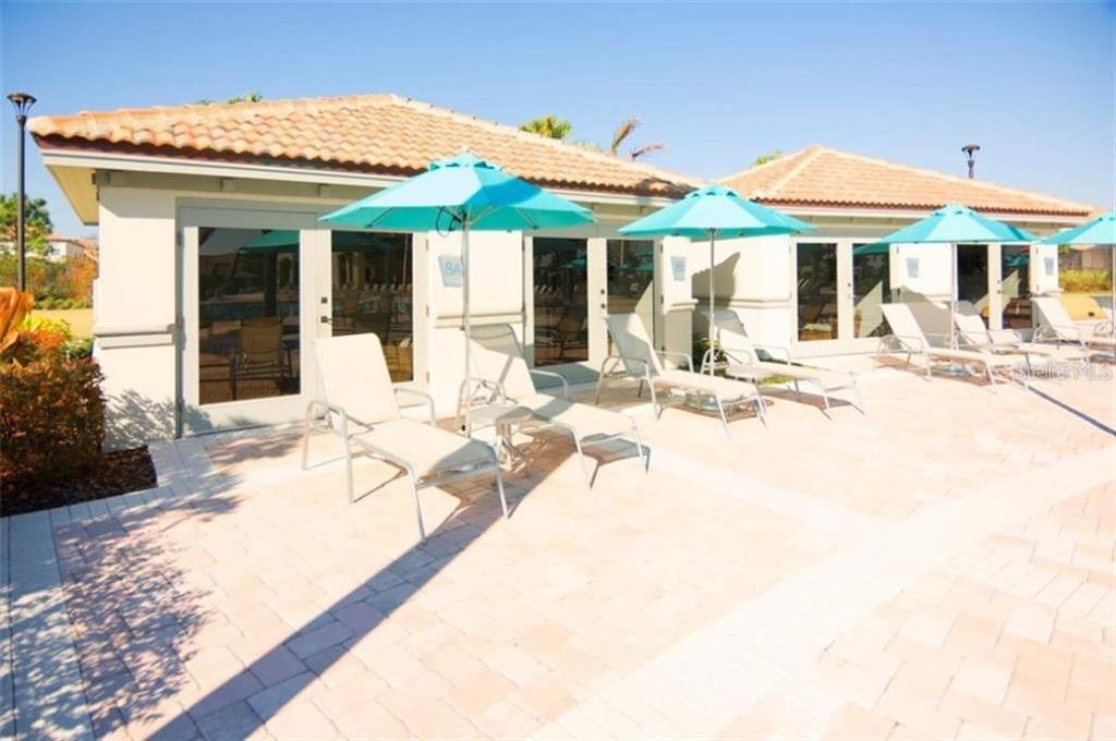 1427 Thunderbird Road Davenport, FL 33896 - Photo 42 of 52 a view of a patio with a table and chairs under an umbrella