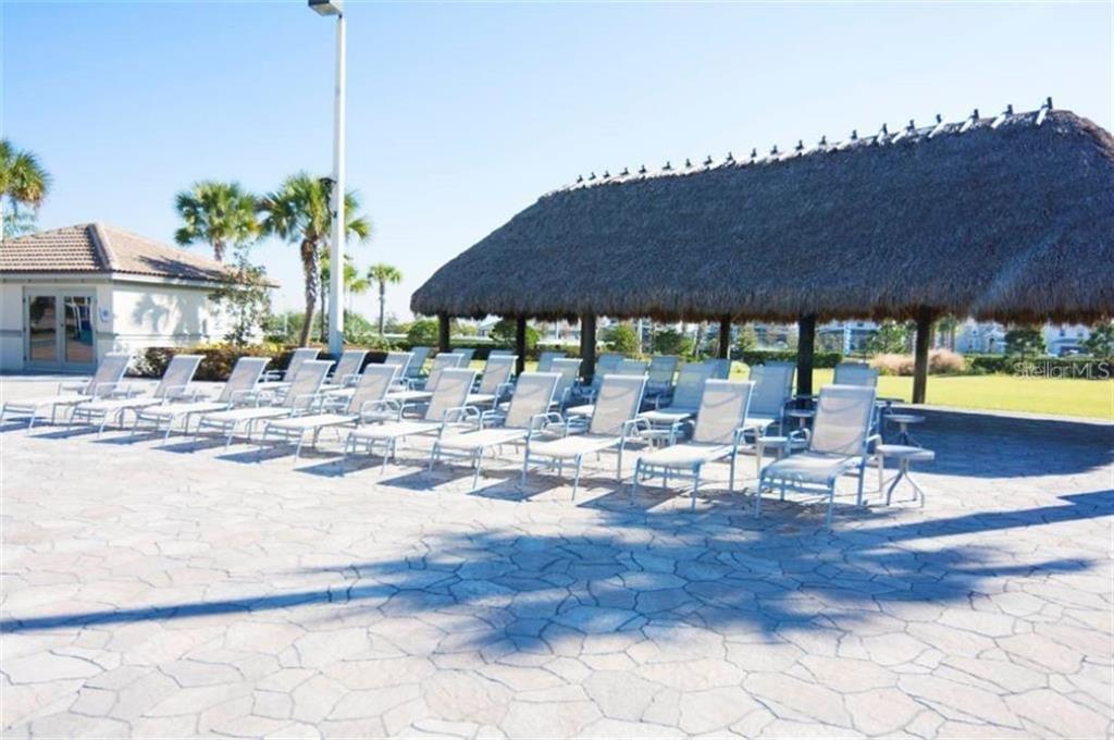 1427 Thunderbird Road Davenport, FL 33896 - Photo 43 of 52 a view of a patio with a table chairs and a fire pit