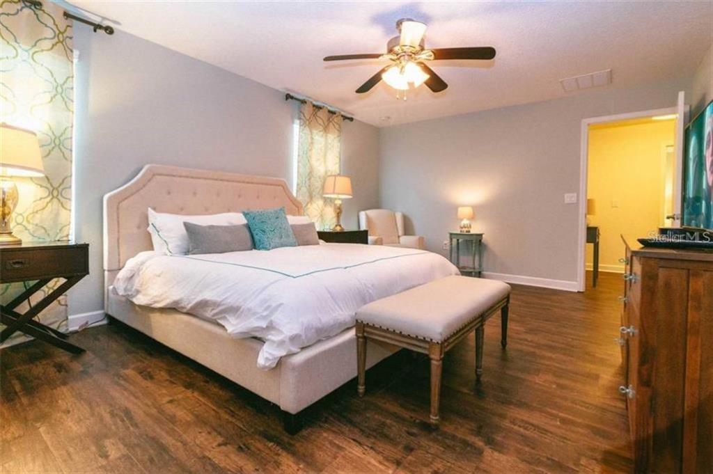 1427 Thunderbird Road Davenport, FL 33896 - Photo 5 of 52 a bedroom with a bed and a chandelier