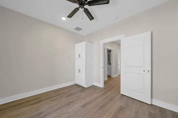 a view of a room with wooden floor and white walls