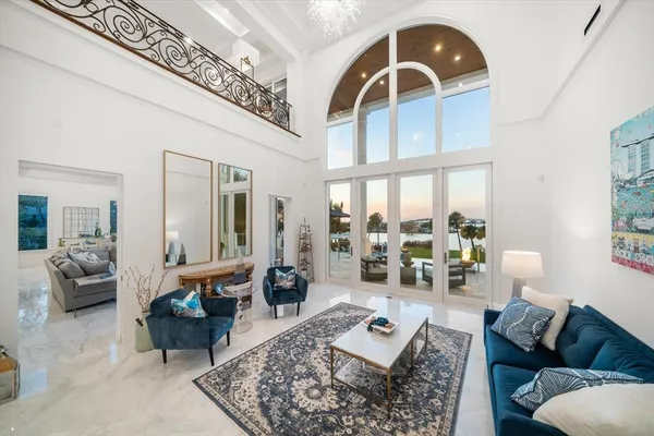 a living room with furniture and floor to ceiling window