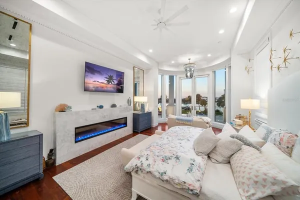a bedroom with furniture and a flat screen tv