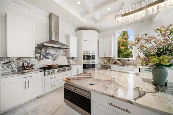 a kitchen with stainless steel appliances white cabinets and a stove