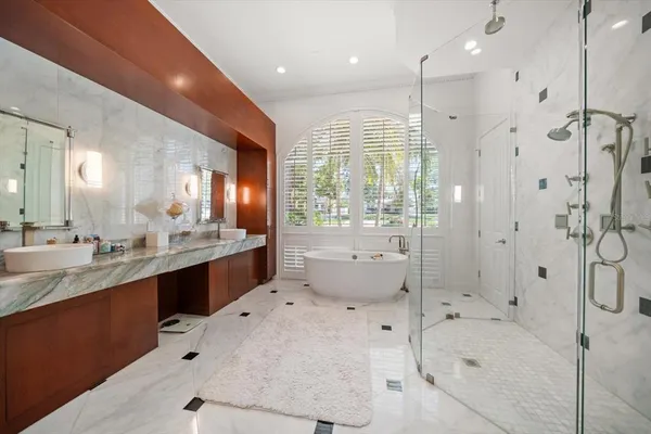 a large bathroom with a granite countertop sink a large mirror and shower