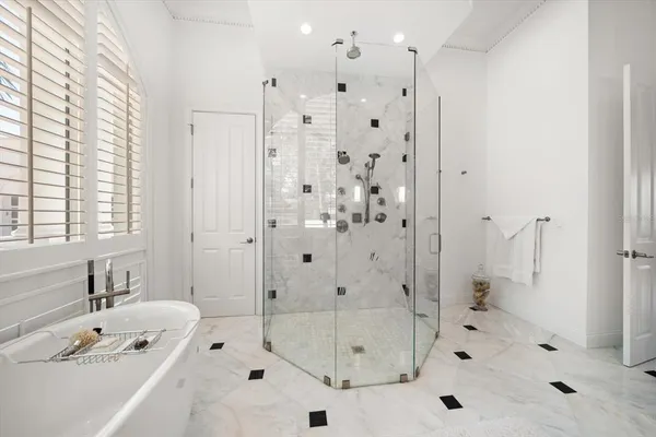 a bathroom with a bath tub a shower and a sink