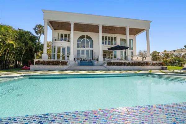 a front view of a house with swimming pool and porch