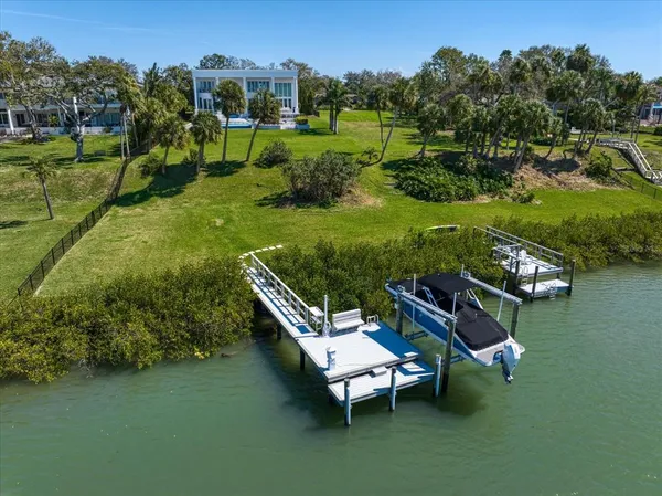 an aerial view of a house with outdoor space and lake view