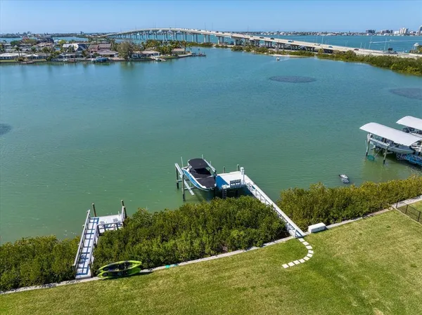 an aerial view of a house with a yard and lake view