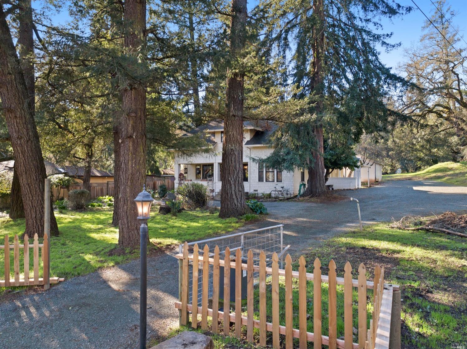a view of a wooden house next to a yard