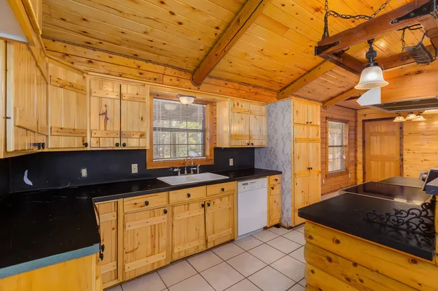 a kitchen with stainless steel appliances granite countertop a sink and cabinets