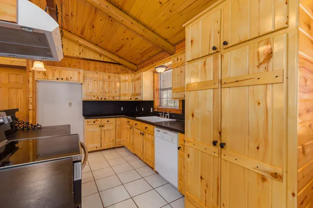 a kitchen with stainless steel appliances a refrigerator and cabinets