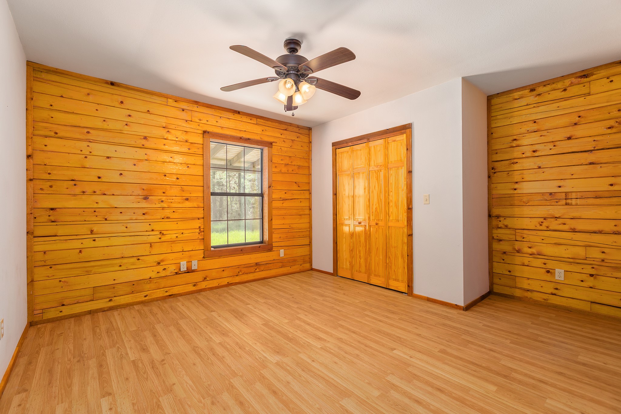 1152 Loving Road Lufkin, TX 75901 - Photo 21 of 42 a view of an empty room with a window and wooden floor