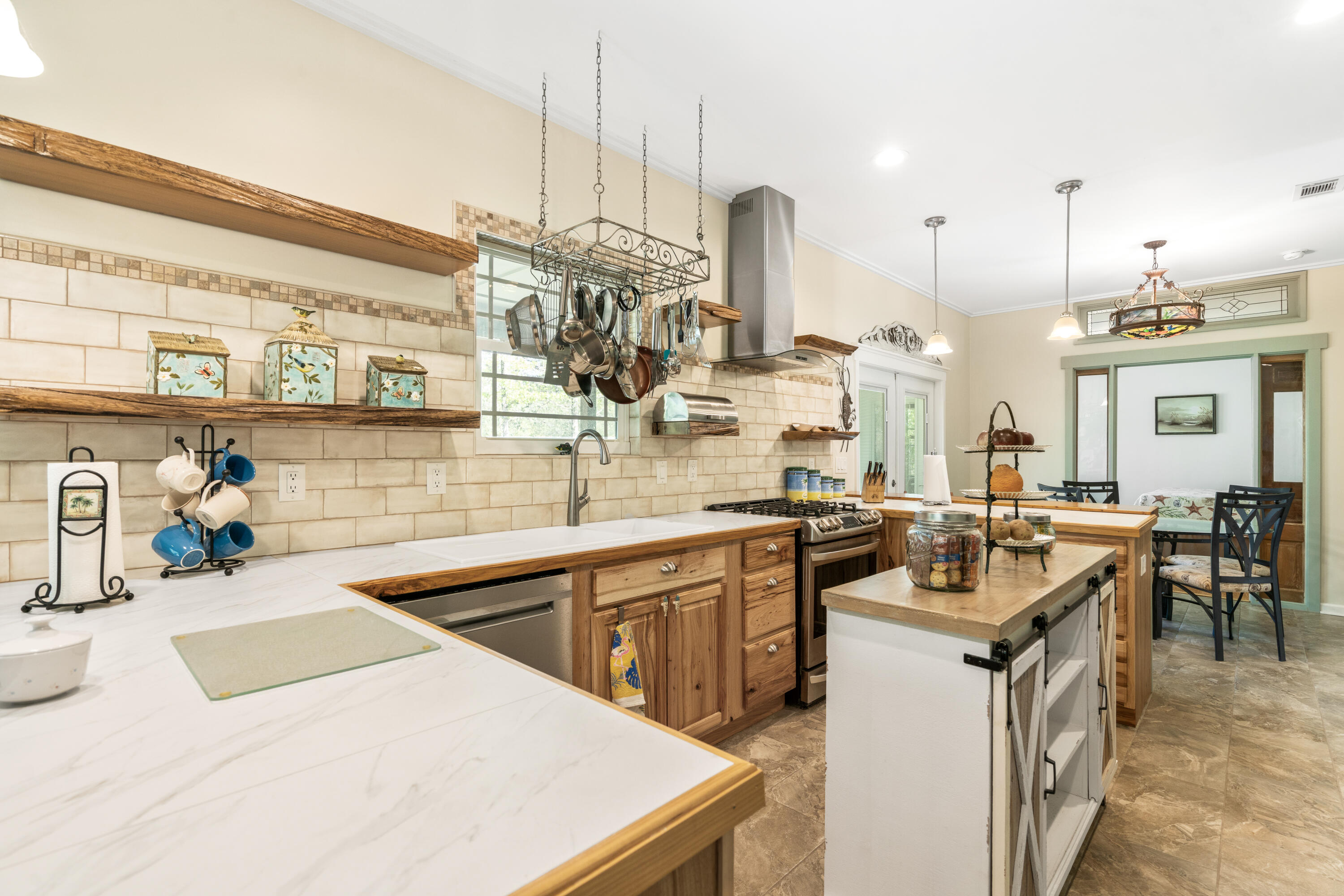 528 Bay Grove Road Freeport, FL 32439 - Photo 10 of 68 a kitchen with a sink a stove and chairs