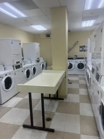 a bathroom with a sink a washer and dryer
