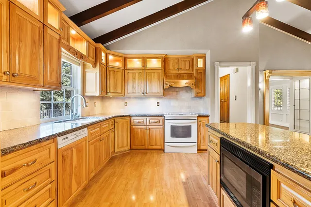 a bathroom with a granite countertop bathtub shower and toilet