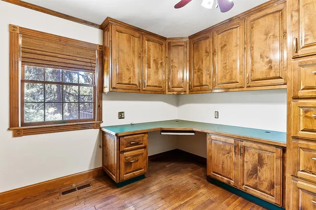 a view of a room with wooden floor and window