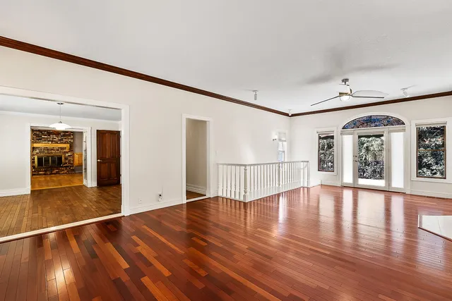 a view of an empty room with wooden floor