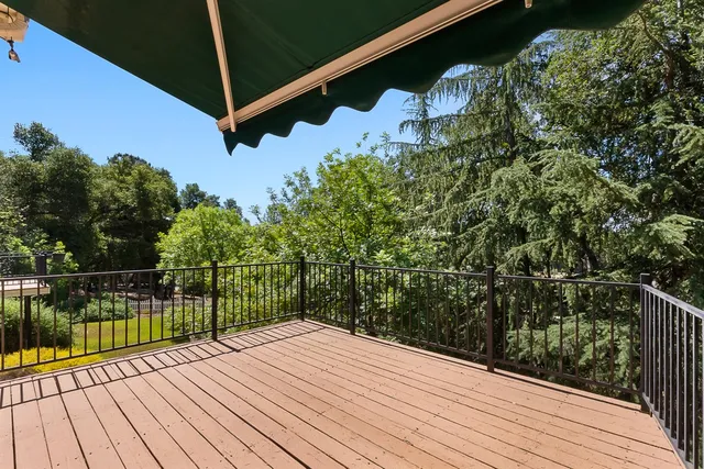 an aerial view of residential house with outdoor space and trees all around