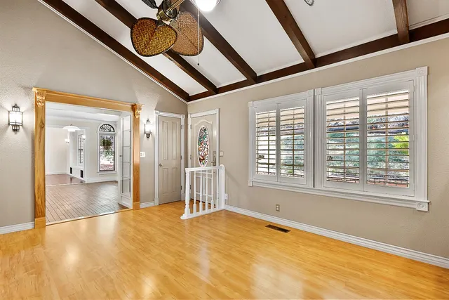 a kitchen with stainless steel appliances granite countertop a stove and a large window