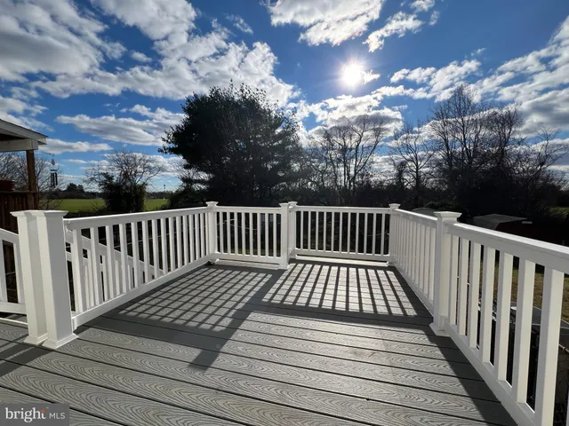 a view of balcony with wooden floor and fence