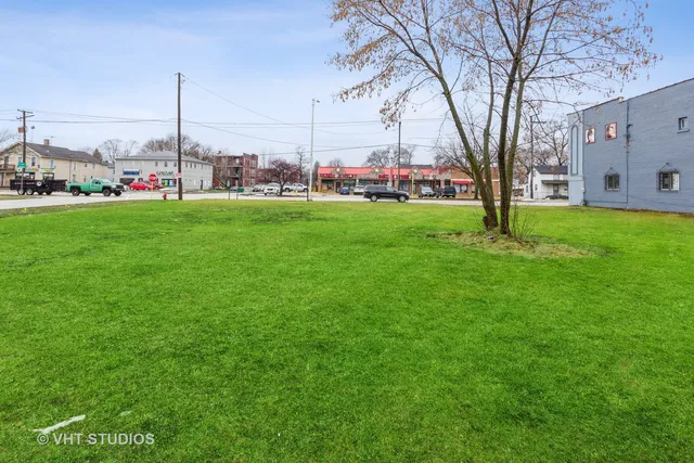 a view of yard with green space and lots of tall trees