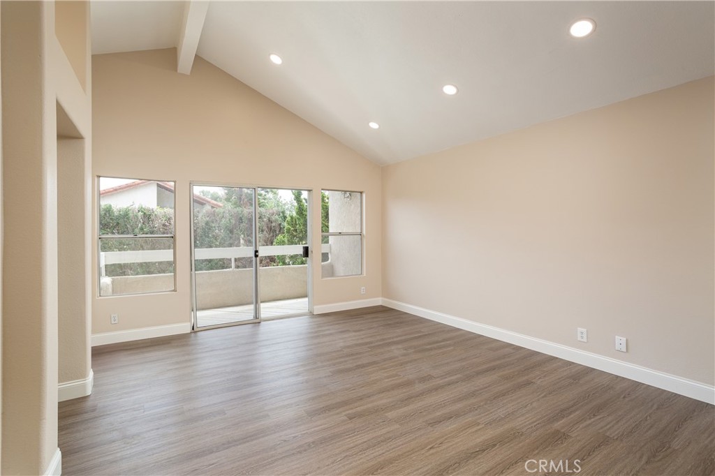 7 Copper Hill Irvine, CA 92620 - Photo 16 of 29 a view of an empty room with wooden floor and a window