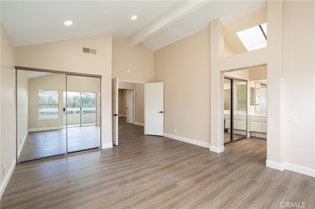 7 Copper Hill Irvine, CA 92620 - Photo 17 of 29 a view of an empty room with wooden floor and a window