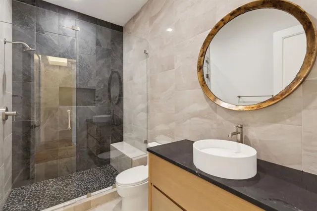 a bathroom with a sink toilet and shower