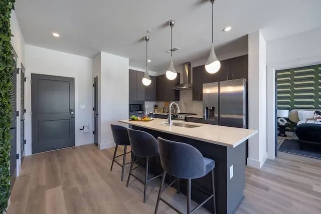 a large kitchen with a table and chairs