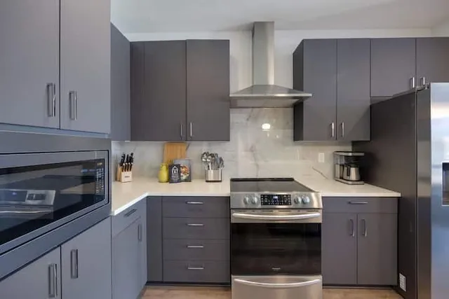 a kitchen with a stove and a refrigerator