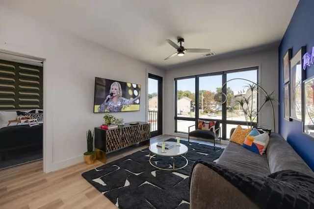a living room with furniture and a floor to ceiling window
