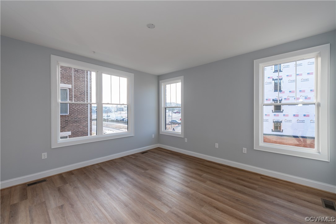1712 Old Brick Road, Unit 13A Henrico, VA 23233 - Photo 12 of 25 a view of an empty room with wooden floor and a window