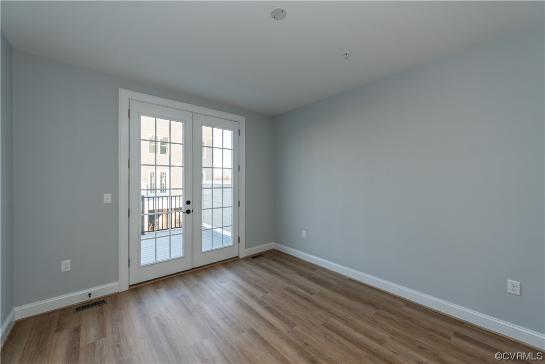 1712 Old Brick Road, Unit 13A Henrico, VA 23233 - Photo 15 of 25 wooden floor in an empty room with a window