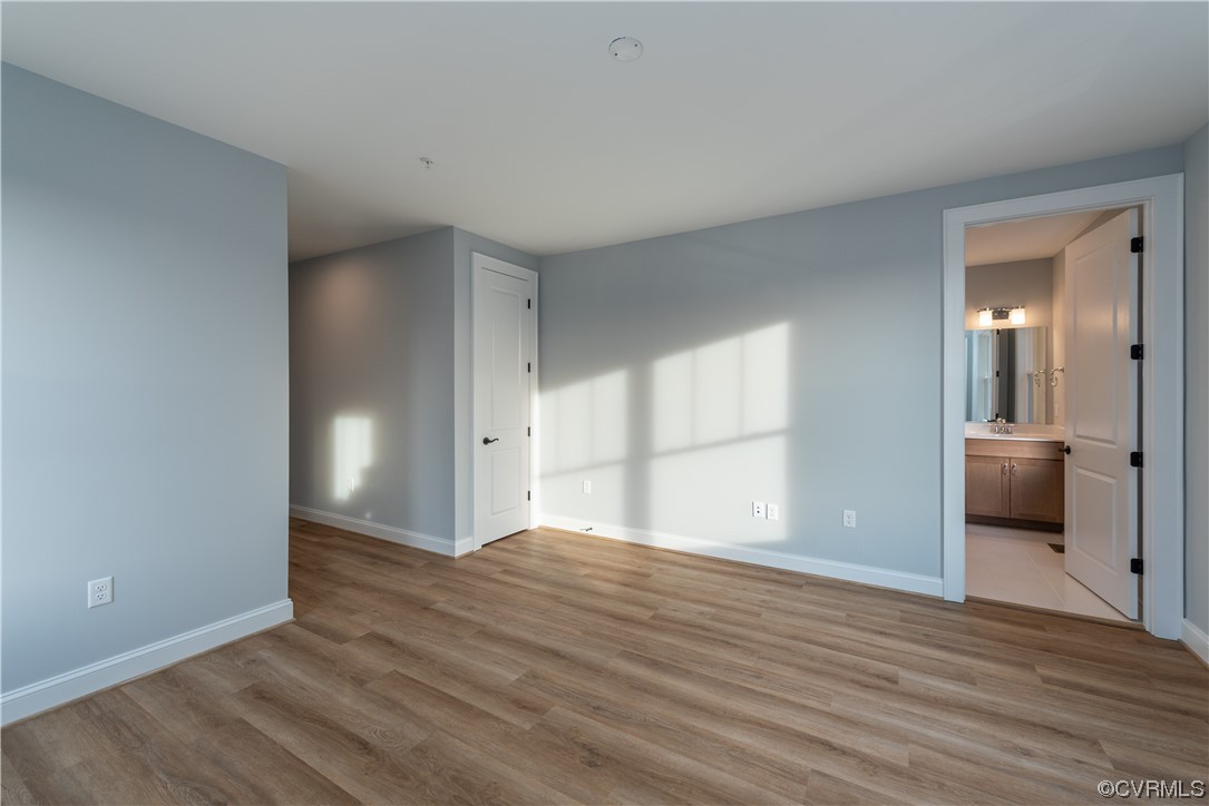1712 Old Brick Road, Unit 13A Henrico, VA 23233 - Photo 9 of 25 a view of an empty room with wooden floor and a window