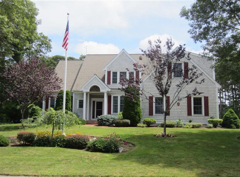 86 Howes Path Dennis, MA 02638 - Photo 1 of 30 a front view of a house with a garden