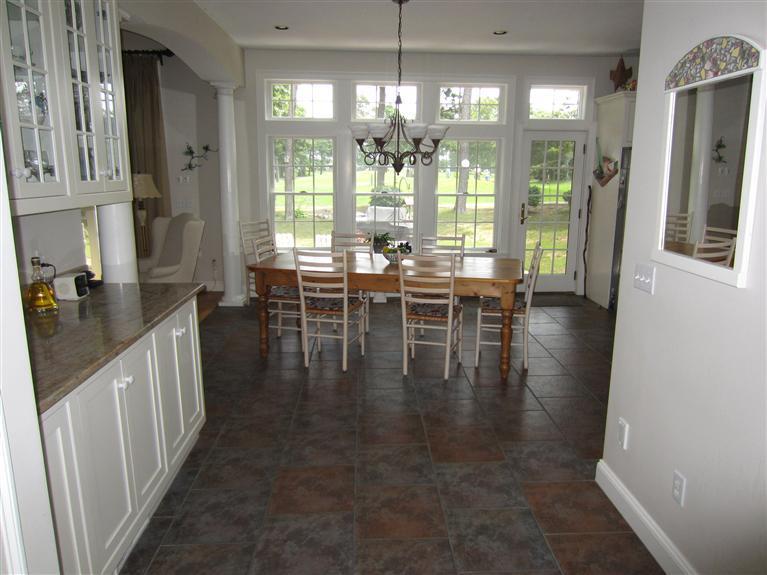 86 Howes Path Dennis, MA 02638 - Photo 11 of 30 a dining room with wooden floor a chandelier