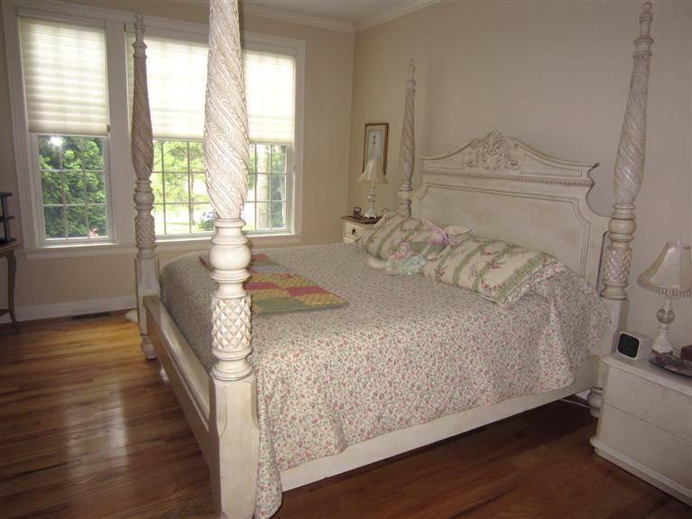 86 Howes Path Dennis, MA 02638 - Photo 17 of 30 a spacious bedroom with a bed and wooden floor